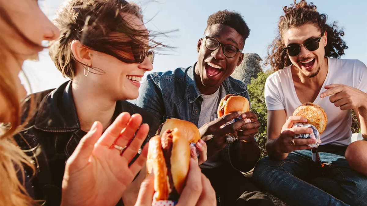 People enjoying burgers together.